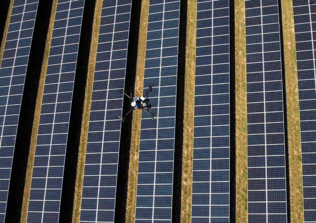 Drone hovering over solar panels